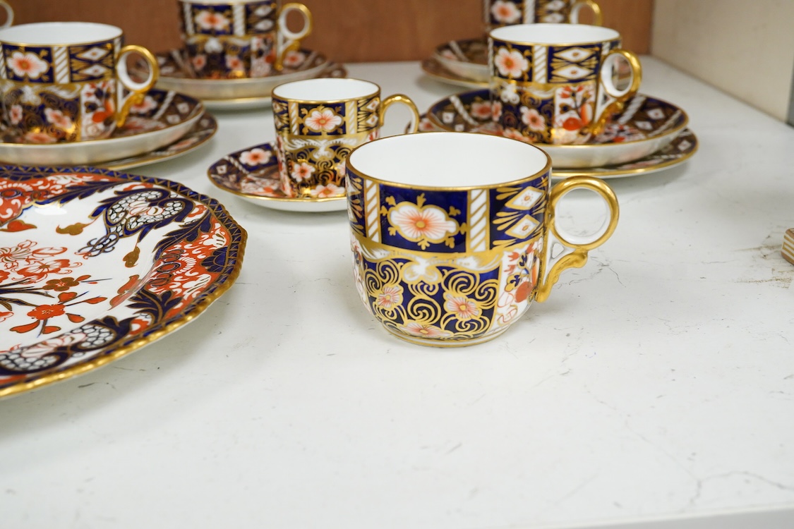 A Crown Derby Imari seven trio place setting, three other cups and two saucers, a large plate and a pair of Doccia- style vases, 18cm high